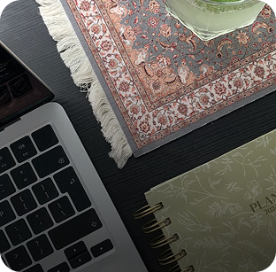 Laptop and planner with a cup of limonade on a coaster